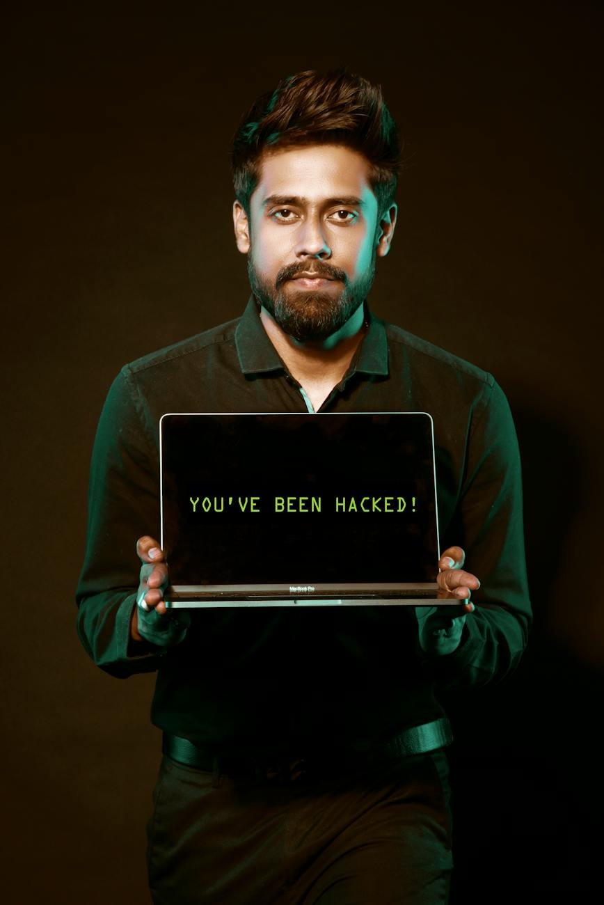 man holding laptop computer with both hands